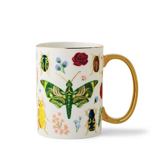 White mug with gold rim and handle features colorful designs of insects and flowers