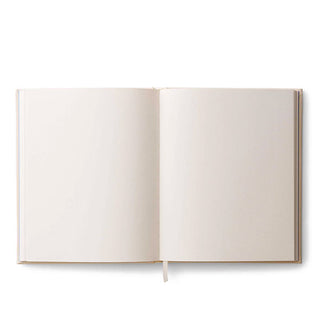 Sketchbook interior with blank pages and ribbon bookmark extending from the bottom