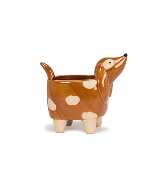 Footed planter shaped like a dachshund with matte beige paws and a shiny brown body with intermittent matte beige spots