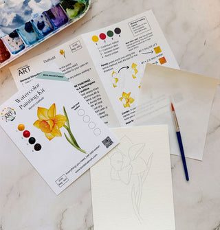 Components of a Daffodil Watercolor Painting Kit on a marble tabletop
