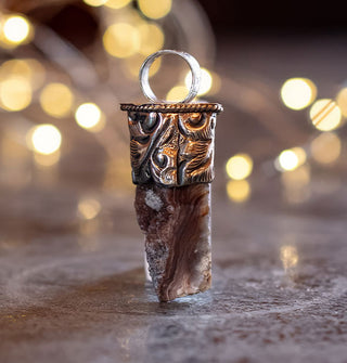 Dark orca agate chunk pendant set in engraved silver top with round bail