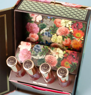 Opened TokyoMilk Dead Sexy Alchemy Kit perfume sampler box reveals colorful floral interior print and four labeled bottles