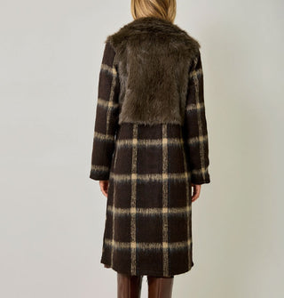 Model wears a brown and tan plaid brushed fiber coat with solid brown faux fur bodice
