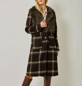 Model wears a brown and tan plaid brushed fiber coat with solid brown faux fur bodice