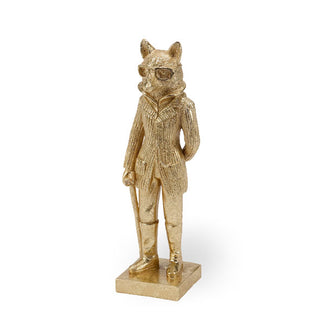 Gold statue of a fox wearing glasses, a jacket, pants, boots, and holding a cane, standing on a square base