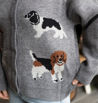 Closeup of two dog designs on a gray button-down cardigan sweater
