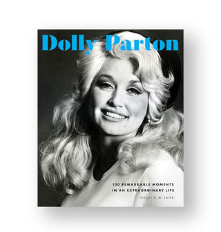 Cover of Dolly Parton: 100 Remarkable Moments in an Extraordinary Life features a black and white portrait of the smiling artist under blue title lettering