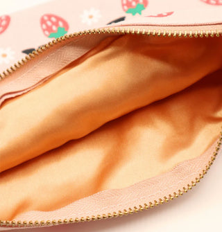 Unzipped pouch reveals a gold interior lining