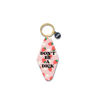 Elongated pink diamond-shaped acrylic motel-style keychain with gold split ring features a strawberry and daisy print and the words, "Don't be a dick" in bold, black lettering