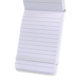 Notebook interior reveals lined pages and a white elastic band closure