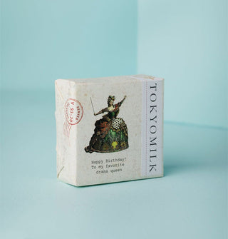 Wrapped square bar of TokyoMilk soap features illustration of a woman in Baroque fashion holding a wand above the words, "Happy Birthday! To my favorite drama queen"