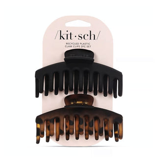 Two extra-large Recycled Plastic Claw Clips, one matte black and the other matte brown tortoise, on light pink Kitsch product card