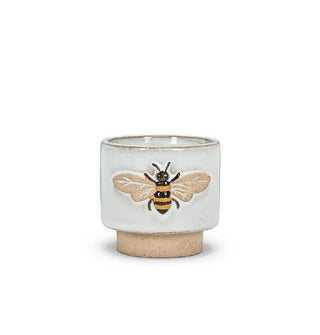Grey ceramic pot with matte brown pedestal base and embossed bee graphic on the side