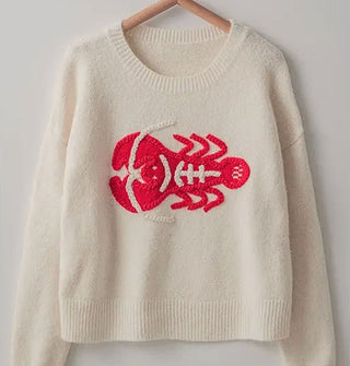 Ivory sweater with bright red embroidered lobster design and ribbed neckline and bottom hem