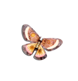 Brown, pink, and yellow butterfly-shaped hair clip with circular accents on the wings