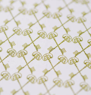 Closeup of notebook's inside page features a print of green, crisscrossed keys