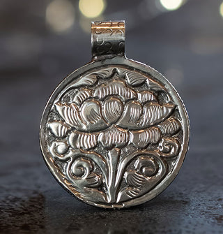 Silver pendant back features ornate engraved flower design