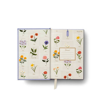 Inside cover of a journal features colorful floral illustrations
