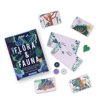 Some cards and pieces belonging to the Flora & Fauna rainforest game are shown with the box