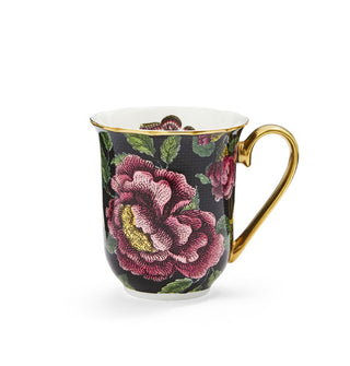 Mug with lush floral pattern on a black background features a white interior with butterfly graphic partially visible and a gold rim and handle