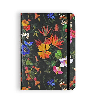Black journal hardcover with colorful, ornate floral designs is held closed by a black elastic band
