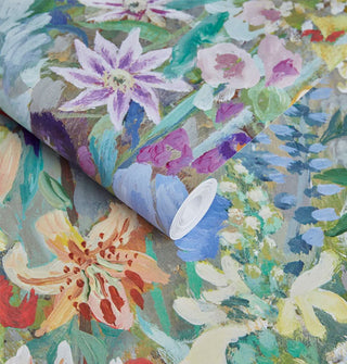 Roll and sample of colorful floral print wallpaper in an oil painting style