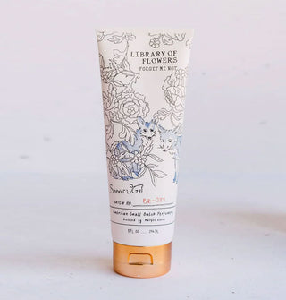 White bottle of Library of Flowers Forget Me Not Shower Gel with bronze-colored cap features illustration of two blue foxes among florals