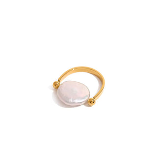 Horseshoe-shaped gold ring with a rounded pearl set between two ball band ends