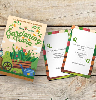 Gardening Trivia box and two sample cards rest on a wooden surface