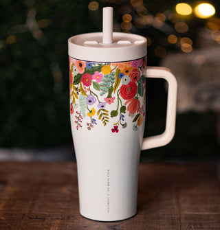 White thermos with handle, lid, and straw features a colorful floral design on its top half