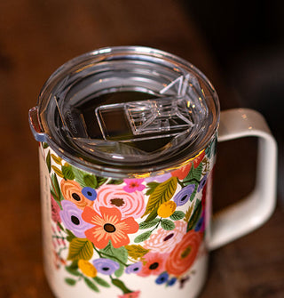 Top view of the clear lid on a white mug with colorful floral design
