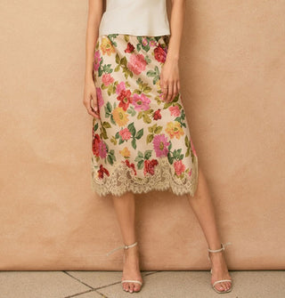 Model wears a knee-length floral-patterned skirt with lace hem