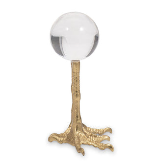 Clear acrylic orb on a gold stand designed to resemble bird's feet