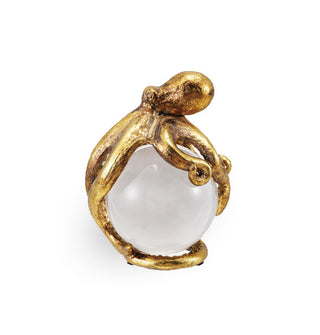 Gold octopus figurine wrapped around a glass orb
