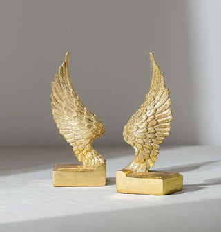 Set of metallic gold wing bookends with rectangular bases