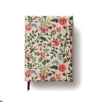 Cloth floral-patterned journal cover with vertical stitching; a ribbon bookmark peeks out from the bottom