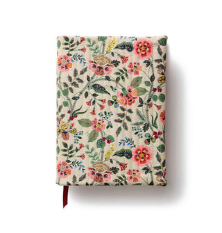 Cloth floral-patterned journal cover with vertical stitching; a ribbon bookmark peeks out from the bottom