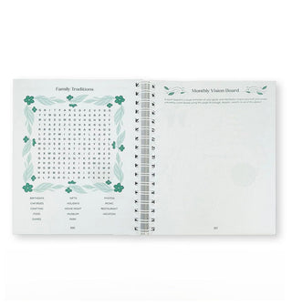 Page spread from spiral-bound Gratitude Puzzle Journal features a Family Traditions word search puzzle and Monthly Vision Board blank page