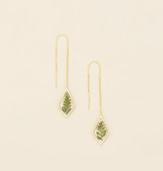 Pair of gold threader earrings with a diamond-shaped dangle containing resin-encased pressed green ferns