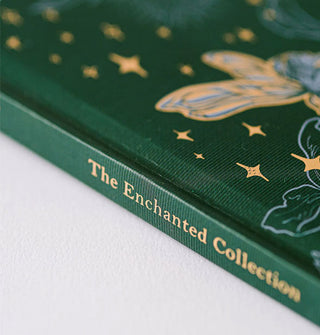 Closeup of the spine of a green book cover that says, "The Enchanted Collection" in gold lettering