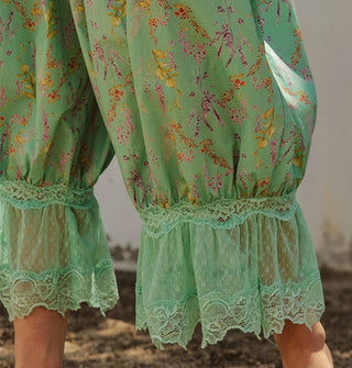 Closeup of the lace trim on a pair of green floral print pantaloons