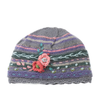 Gray, green, pink, and purple striped beanie with a scalloped edge and textural flower and leaf details