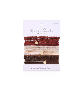 Set of woven Gypsea Bands Waterproof Bracelet Hair Ties in red, beige, and brown, three of which feature gold charms