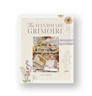 Cover of The Handmade Grimoire features central photograph of a craft space flanked by delicately illustrated flowers