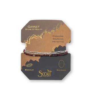 Garnet and silver beaded bracelet/necklace wrapped around product card with gold foil design details