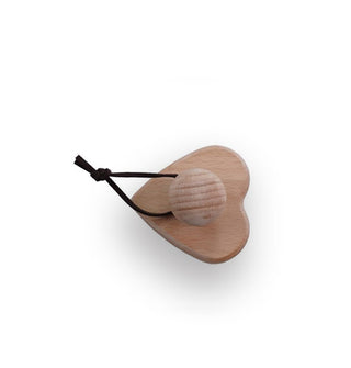 Heart-shaped wooden brush with knob handle and tied leather hanging loop shown from above