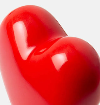 Closeup of the surface of a red ceramic heart bottle stopper topper