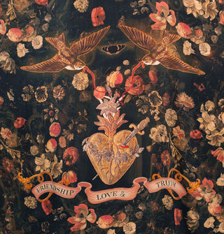 Black robe with floral print and central design of swallows holding red ribbon in their beaks, a sacred heart pierced with a dagger, and a banner that says, "Friendship, Love & Truth"