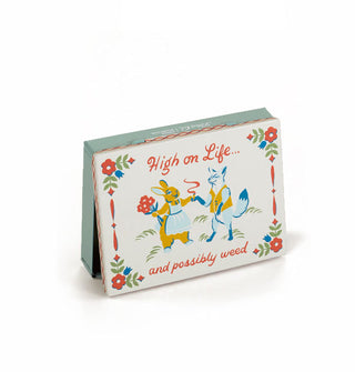 Flat rectangular box features illustration of a fox and bouquet-wielding rabbit exchanging sharing a cigarette and says, "High on Life...and possibly weed" 