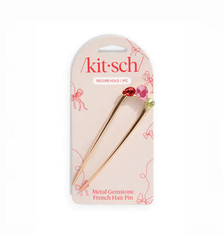 Gold-toned French Hair Pin with red, pink, and green teardrop-shaped rhinestone accents on the top bend is attached to a pale pink Kitsch product card with dark pink lettering and bow designs